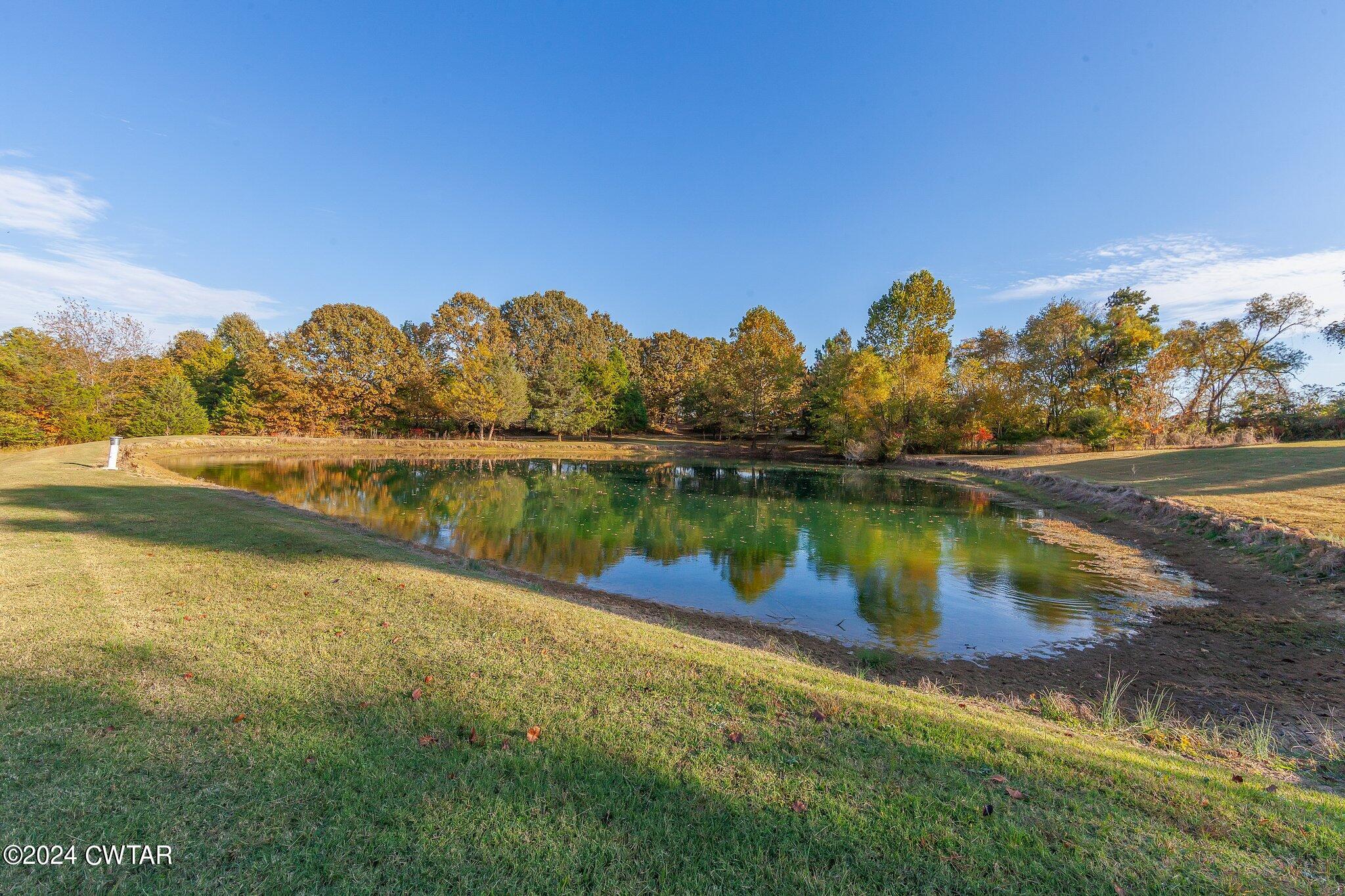 1645 Hopewell Road Lavinia, TN 38348 - Photo 7 of 16 a view of a lake with houses in the back