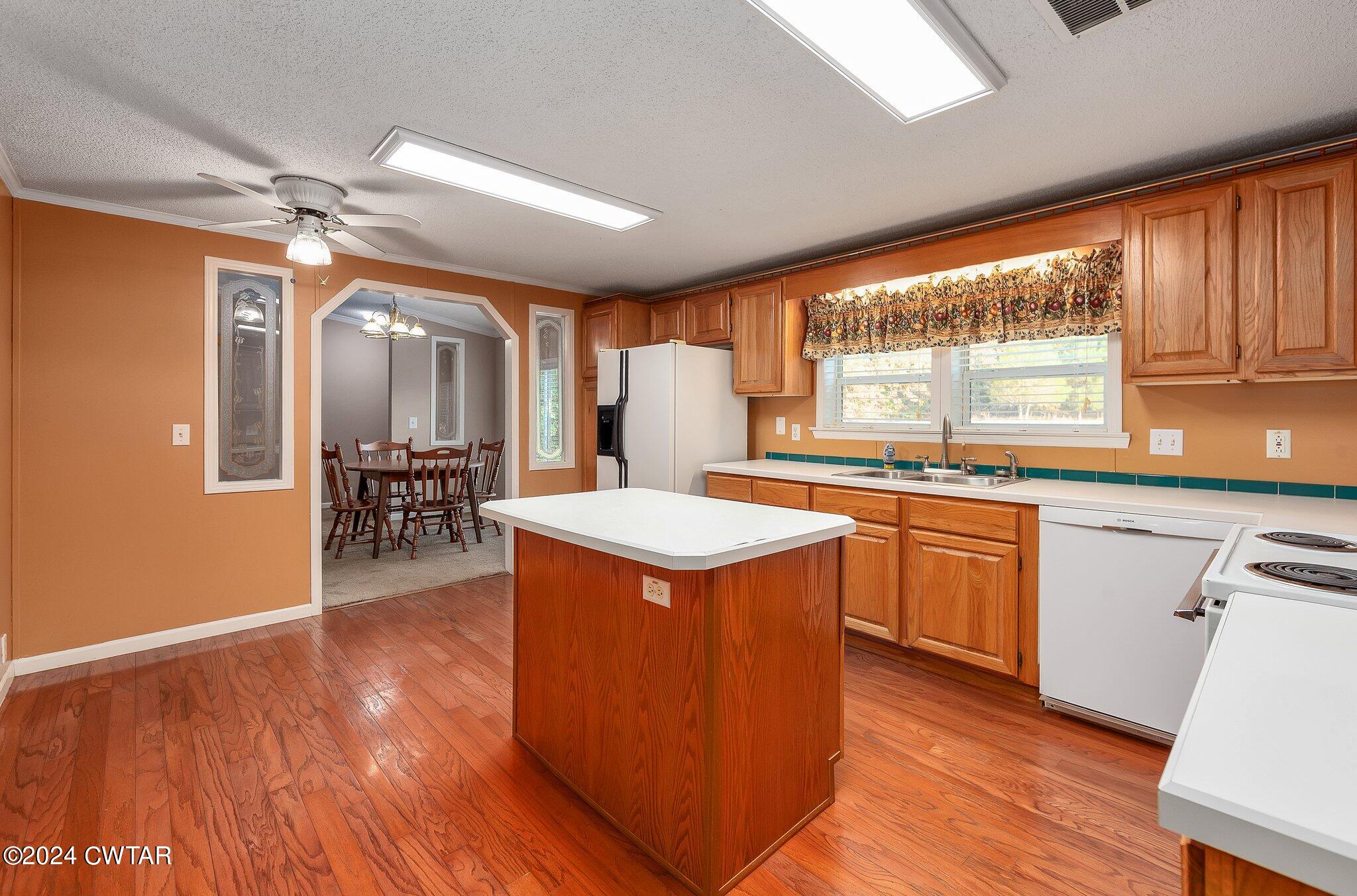 1645 Hopewell Road Lavinia, TN 38348 - Photo 9 of 16 a kitchen with kitchen island wooden floors and stainless steel appliances