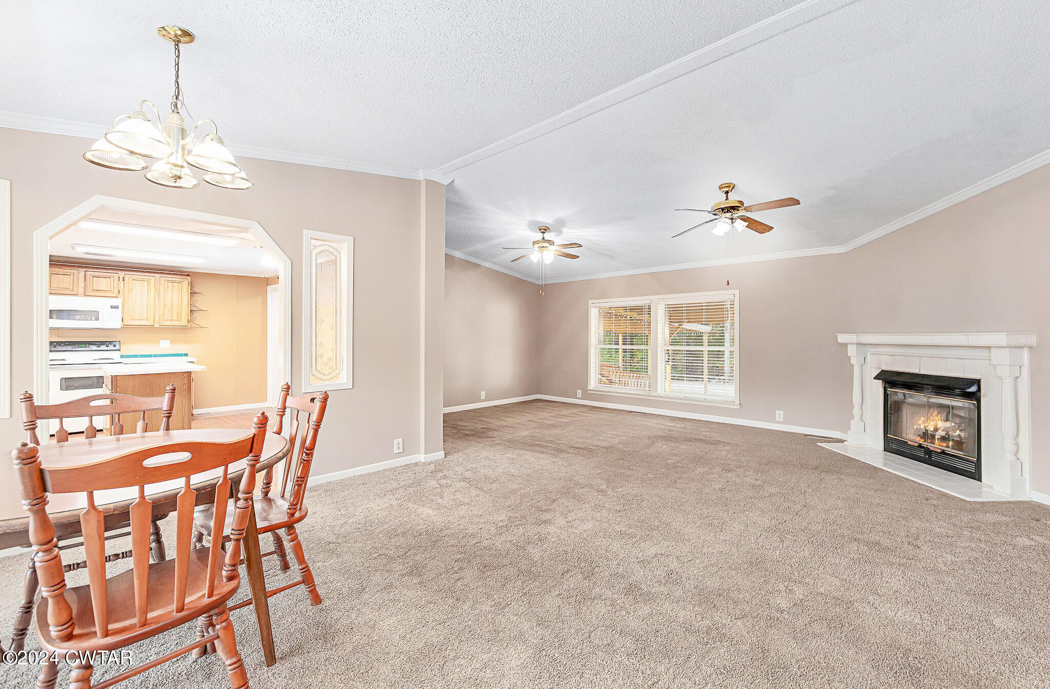 1645 Hopewell Road Lavinia, TN 38348 - Photo 10 of 16 a view of a livingroom with a fireplace window and wooden floor