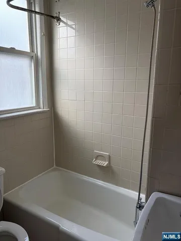 a bathroom with a bathtub and a window