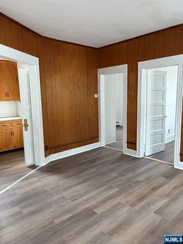 an empty room with wooden floor and closet