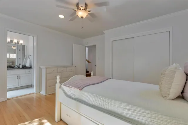 a spacious bedroom with a bed and a chandelier