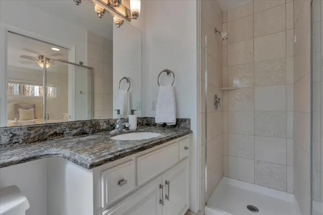 a bathroom with a granite countertop sink and a mirror
