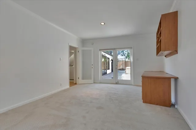 an empty room with windows and closet