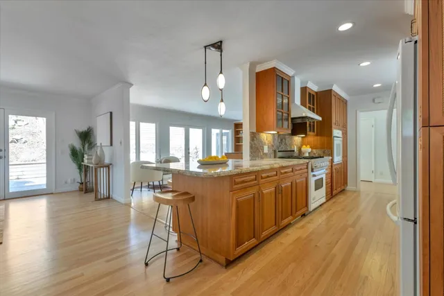 a large kitchen with a table and chairs