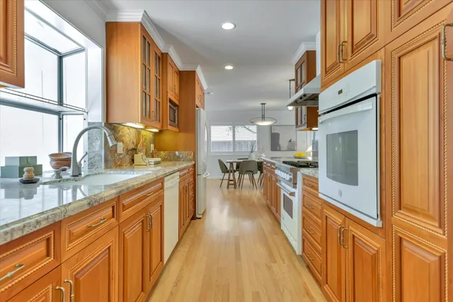 a kitchen with stainless steel appliances a sink and a large window