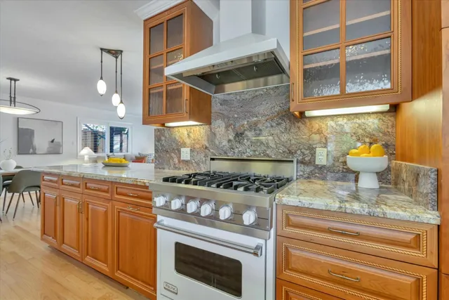 a kitchen with stainless steel appliances granite countertop a stove and a sink