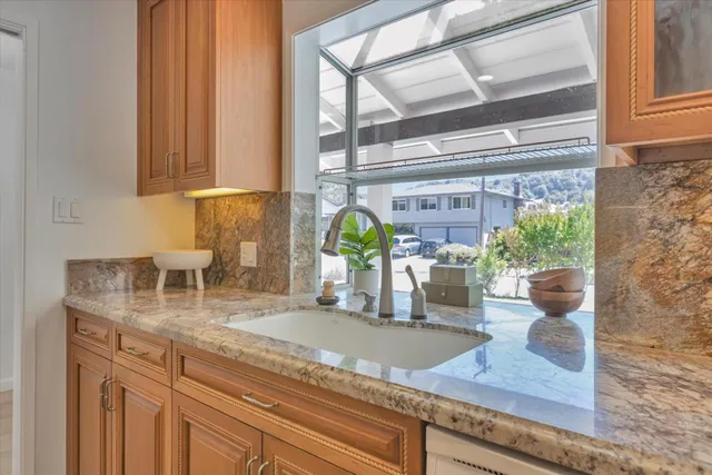 a kitchen with kitchen island sink and potted plant