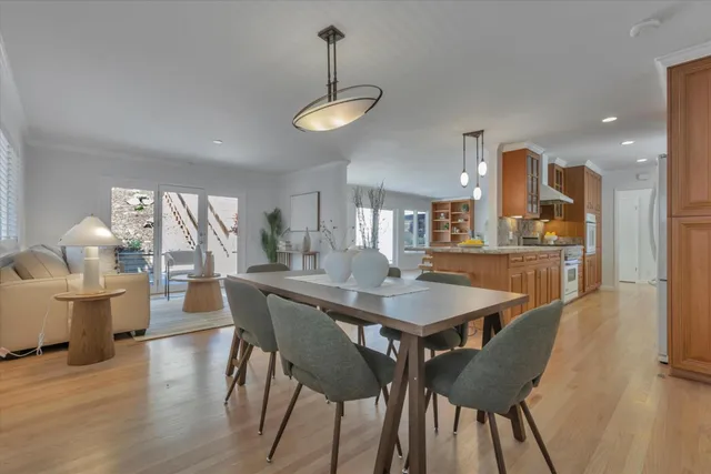 a dining room with furniture and wooden floor