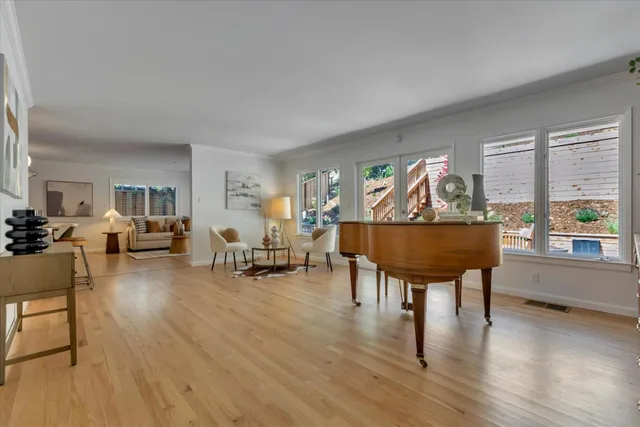 a living room with furniture and a wooden floor