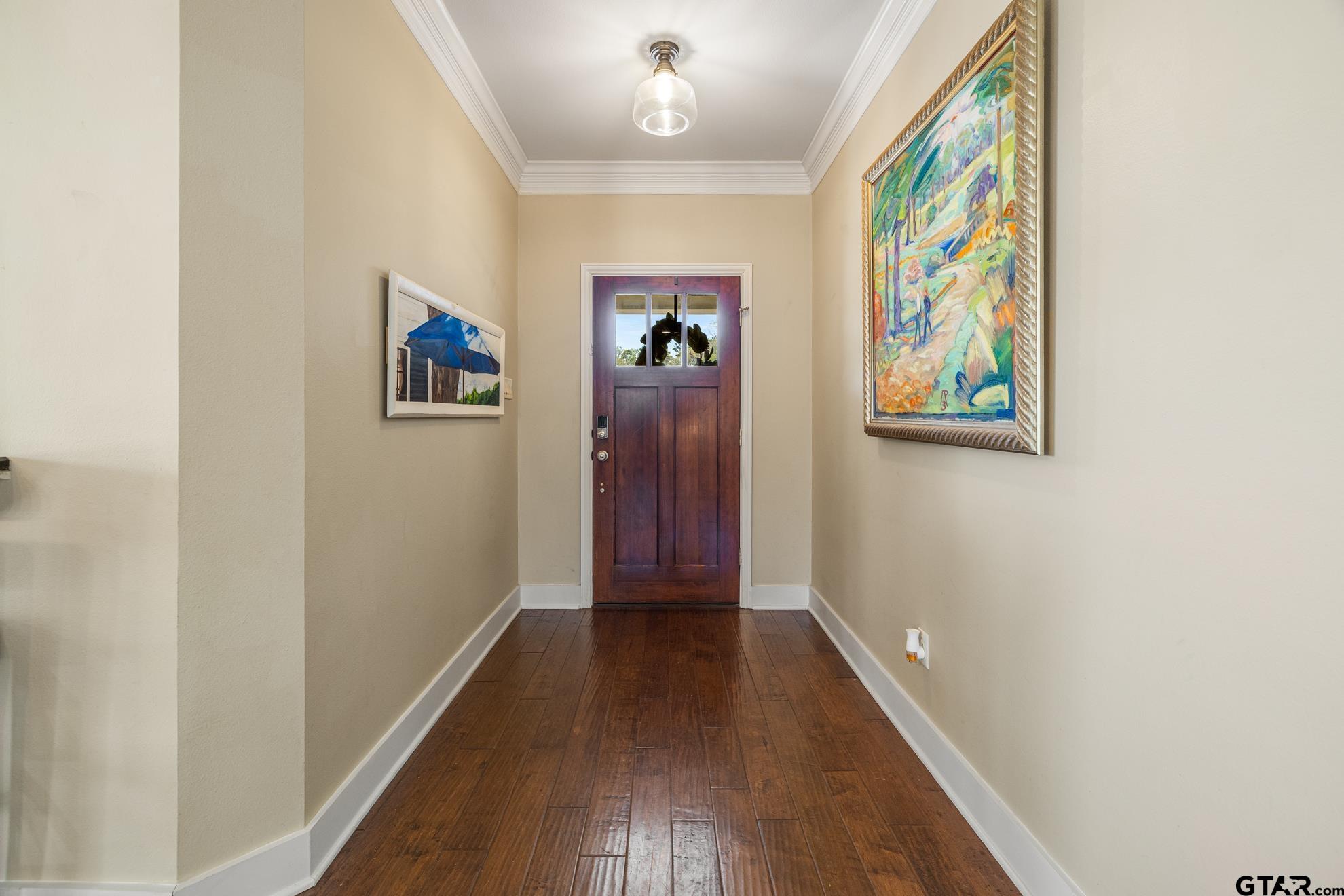 9453 Cherokee Trail Tyler, TX 75703 - Photo 9 of 40 a view of a hallway with wooden floor