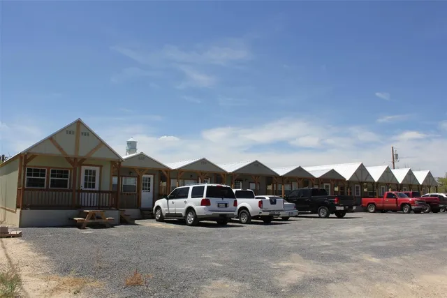 a front view of a house with cars parked