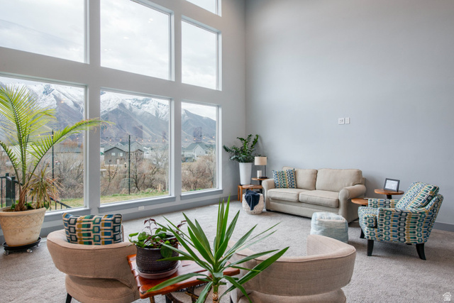 262 North Santa Fe Drive Mapleton, UT 84664 - Photo 10 of 28 Living area with carpet floors, a high ceiling, and a mountain view