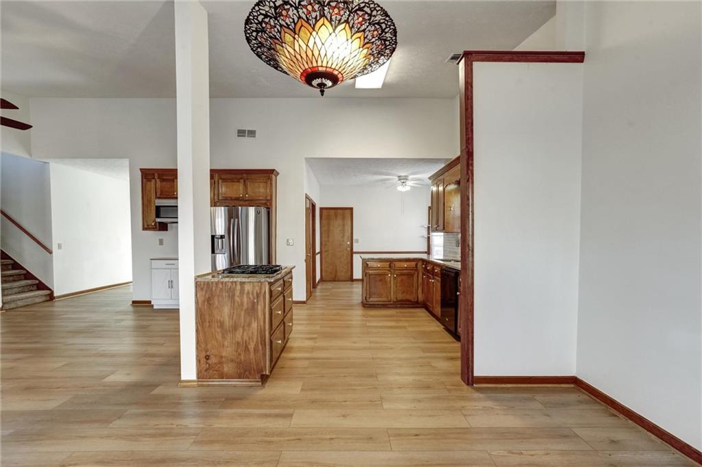487 Ravinia Way Lawrenceville, GA 30044 - Photo 12 of 45 a view of a hallway with wooden floor and a chandelier
