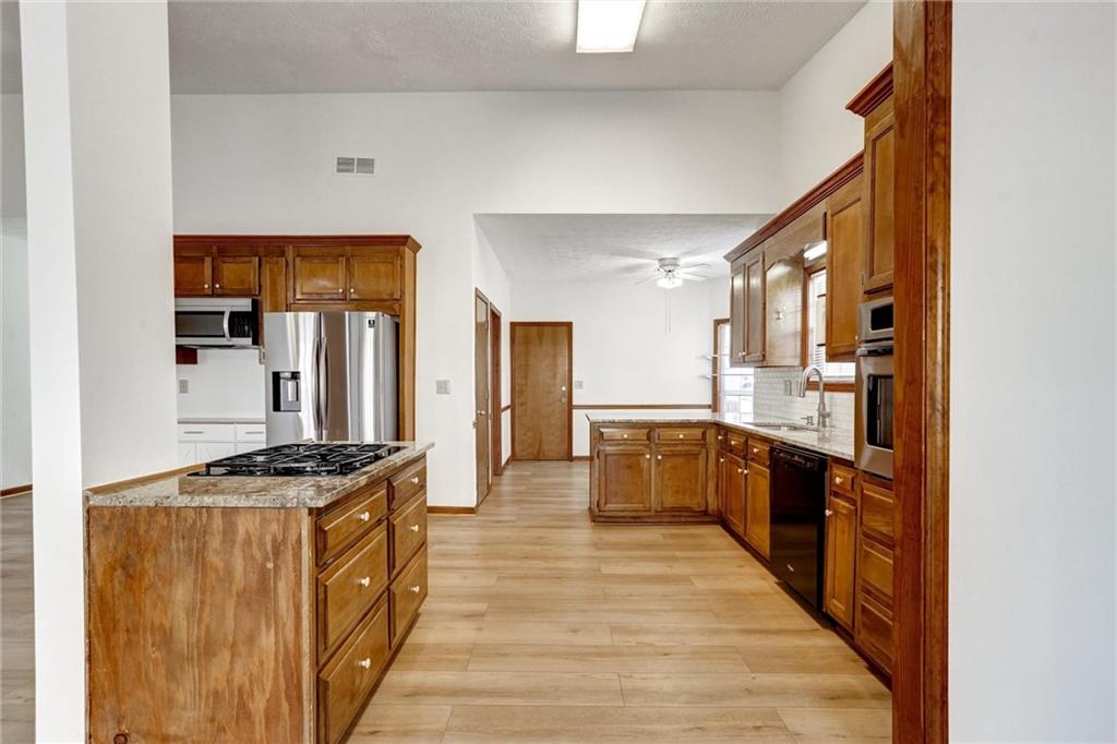 487 Ravinia Way Lawrenceville, GA 30044 - Photo 13 of 45 a kitchen with stainless steel appliances a stove top oven a sink a counter top space and cabinets