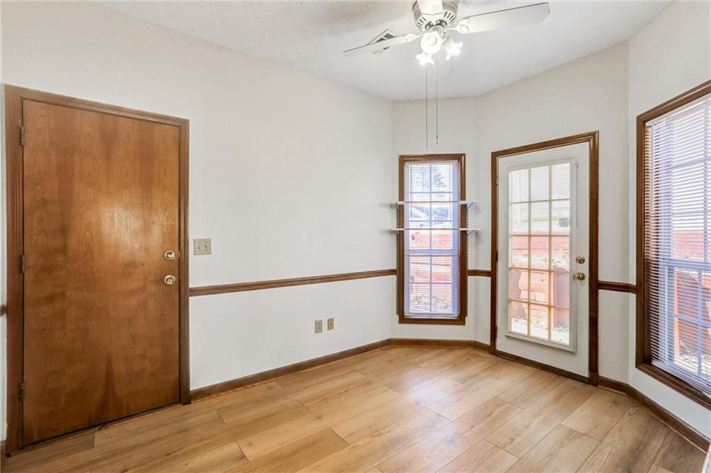 487 Ravinia Way Lawrenceville, GA 30044 - Photo 15 of 45 an empty room with wooden floor cabinet and windows