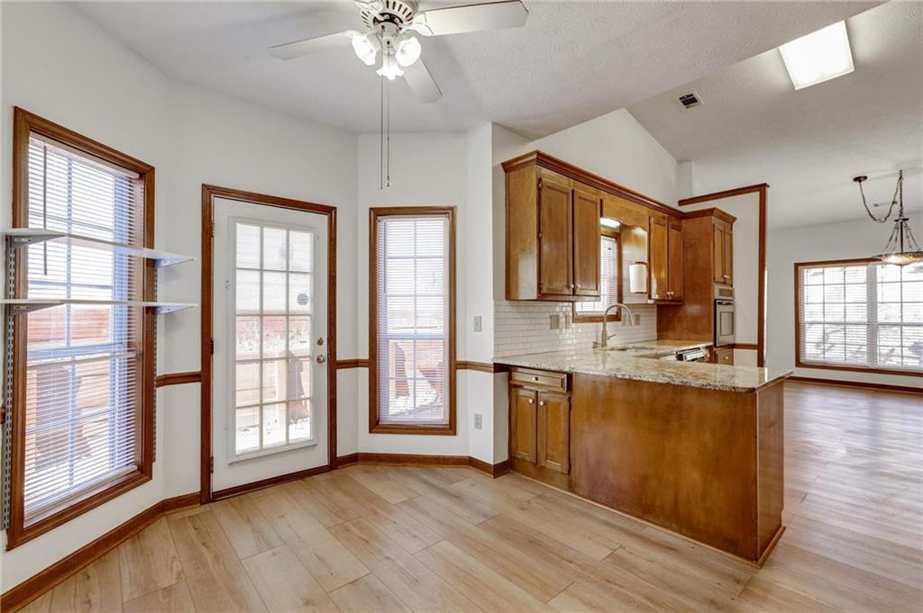 487 Ravinia Way Lawrenceville, GA 30044 - Photo 16 of 45 a view of a kitchen with granite countertop a sink and wooden floor