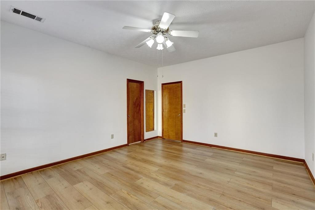 487 Ravinia Way Lawrenceville, GA 30044 - Photo 26 of 45 a view of an empty room with wooden floor