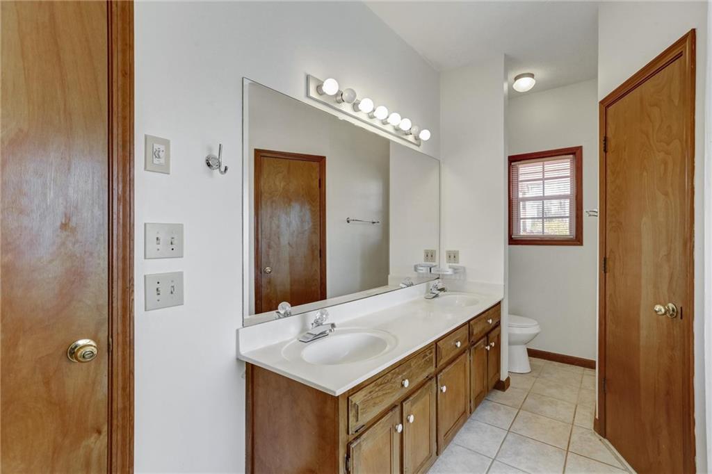 487 Ravinia Way Lawrenceville, GA 30044 - Photo 27 of 45 a bathroom with a double vanity sink and mirror