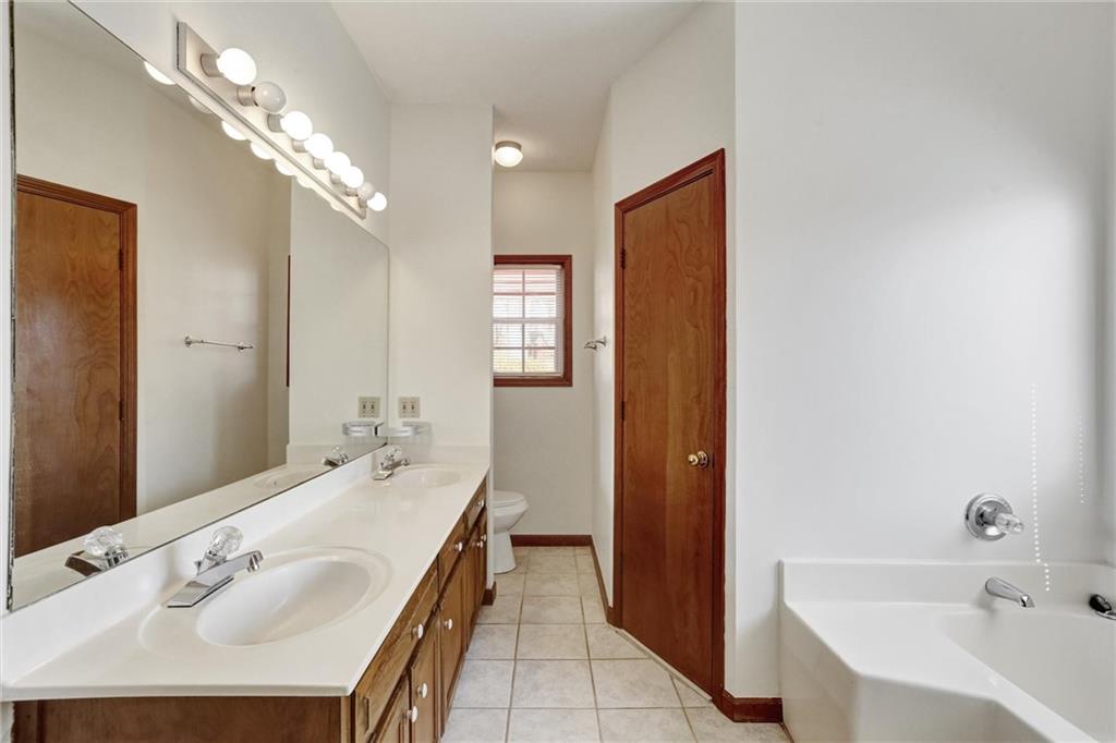 487 Ravinia Way Lawrenceville, GA 30044 - Photo 28 of 45 a spacious bathroom with a tub sink and mirror