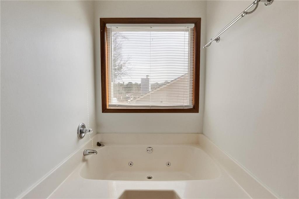 487 Ravinia Way Lawrenceville, GA 30044 - Photo 29 of 45 a white bath tub sitting in a bathroom next to a window