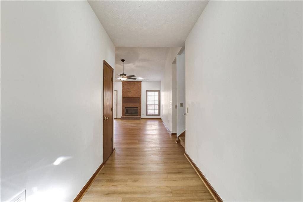 487 Ravinia Way Lawrenceville, GA 30044 - Photo 3 of 45 a hallway with wooden floor and staircase