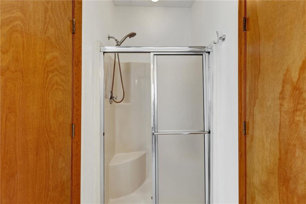 487 Ravinia Way Lawrenceville, GA 30044 - Photo 31 of 45 a bathroom with a glass shower door