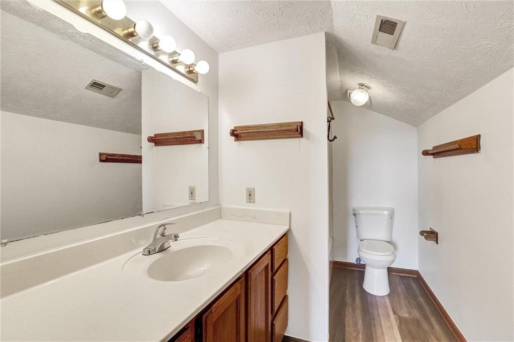 487 Ravinia Way Lawrenceville, GA 30044 - Photo 37 of 45 a bathroom with a sink a toilet and a mirror