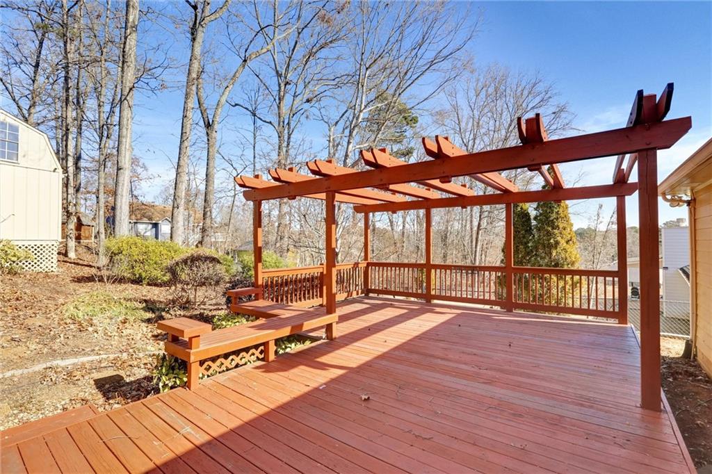487 Ravinia Way Lawrenceville, GA 30044 - Photo 38 of 45 a view of a patio with wooden floor table and chairs