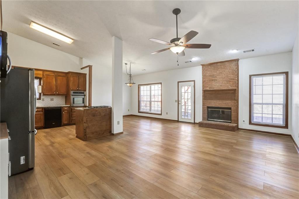 487 Ravinia Way Lawrenceville, GA 30044 - Photo 5 of 45 a view of a kitchen with furniture a ceiling fan and wooden floor