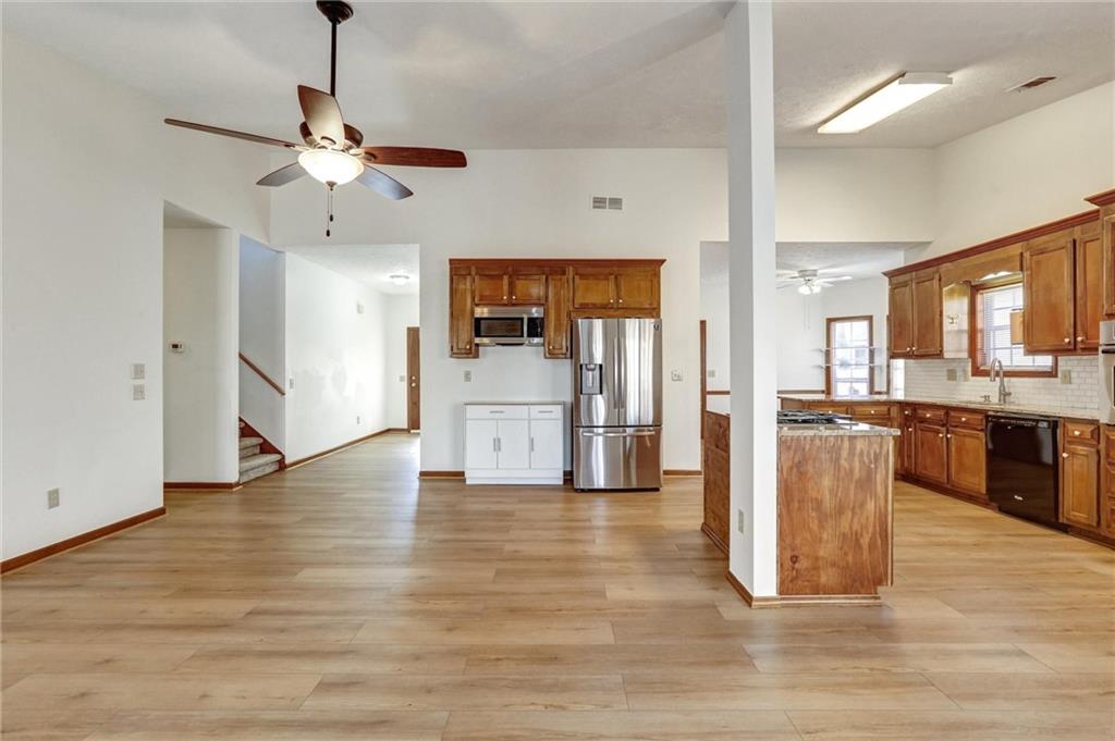 487 Ravinia Way Lawrenceville, GA 30044 - Photo 9 of 45 a view of a kitchen with a sink a refrigerator and a stove