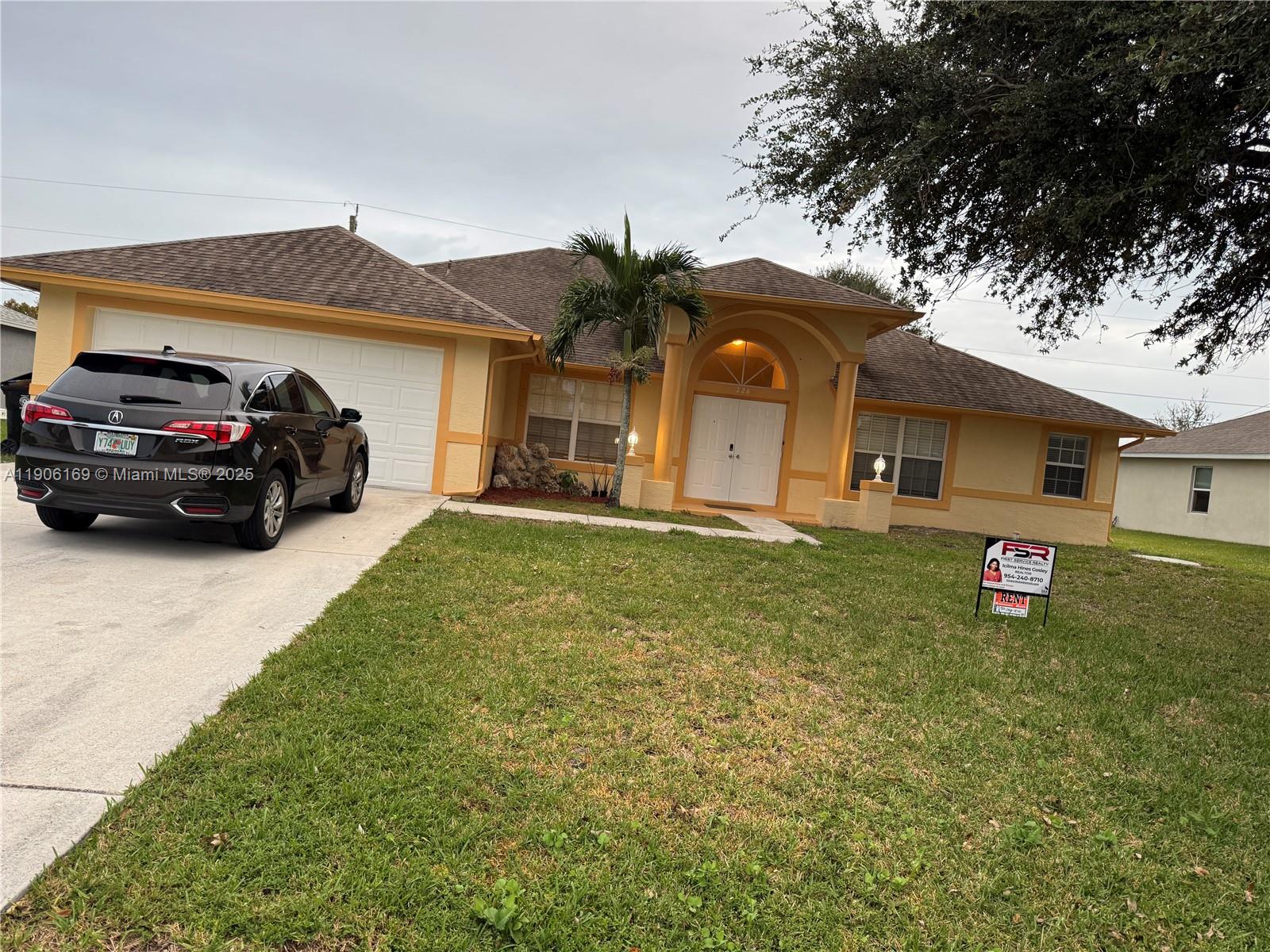 726 Southwest McCracken Avenue Port St. Lucie, FL 34953 - Photo 2 of 10 a car parked in front of a house