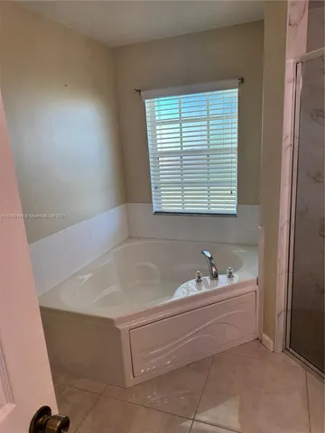 a bath tub sitting in a bathroom next to a window