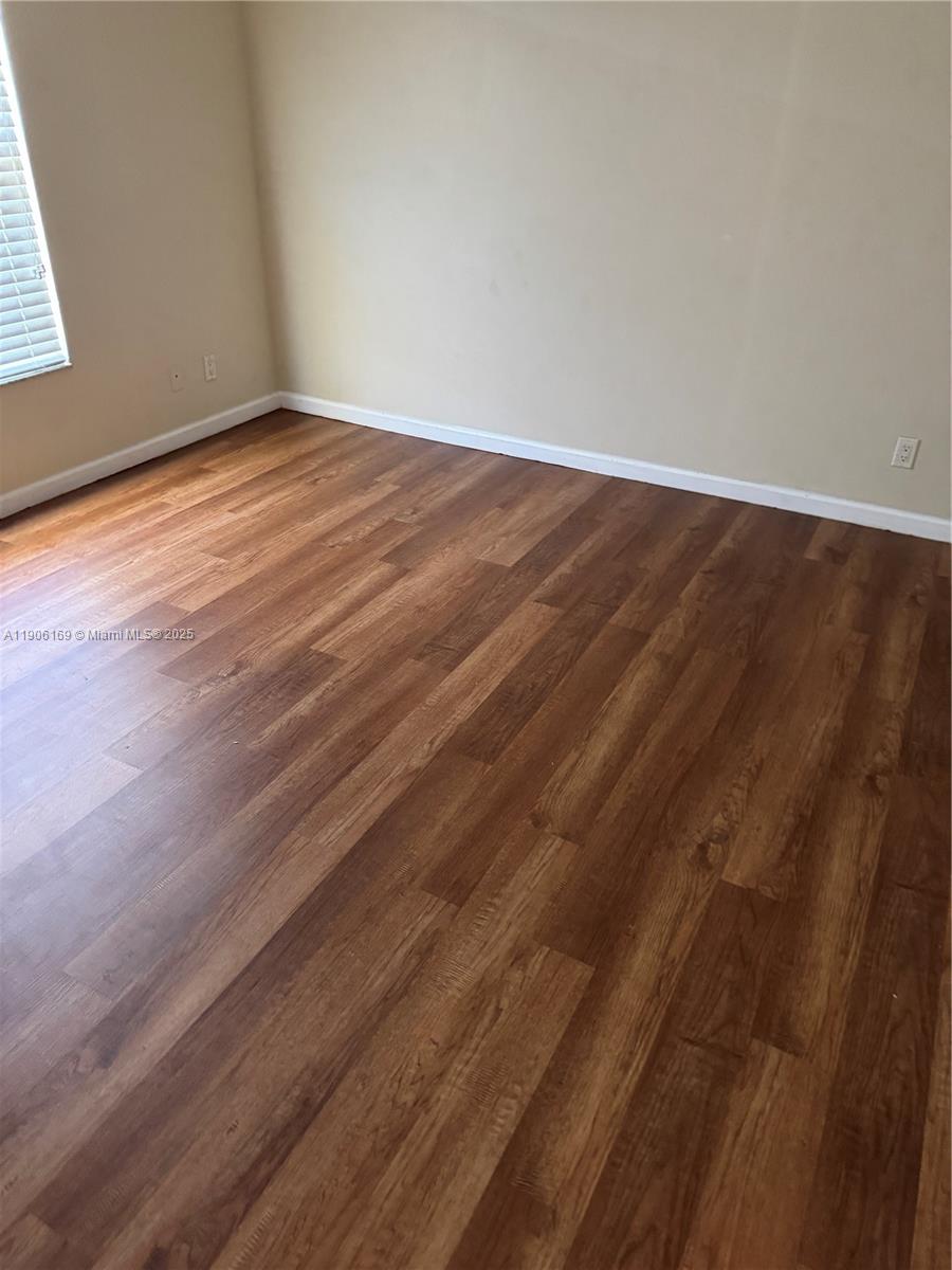 726 Southwest McCracken Avenue Port St. Lucie, FL 34953 - Photo 6 of 10 a view of empty room with wooden floor