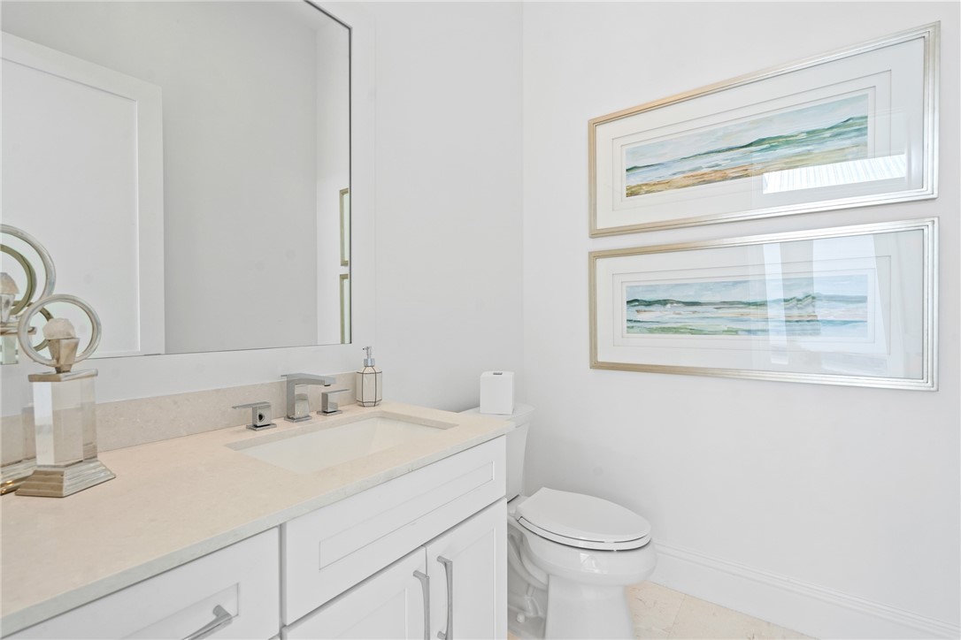 20 Strand Drive Vero Beach, FL 32963 - Photo 20 of 36 a bathroom with a sink a toilet and a mirror