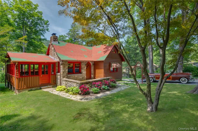 a front view of house with yard and trees