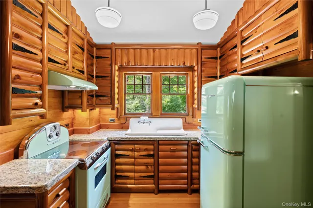 a dining room with furniture window and wooden floor