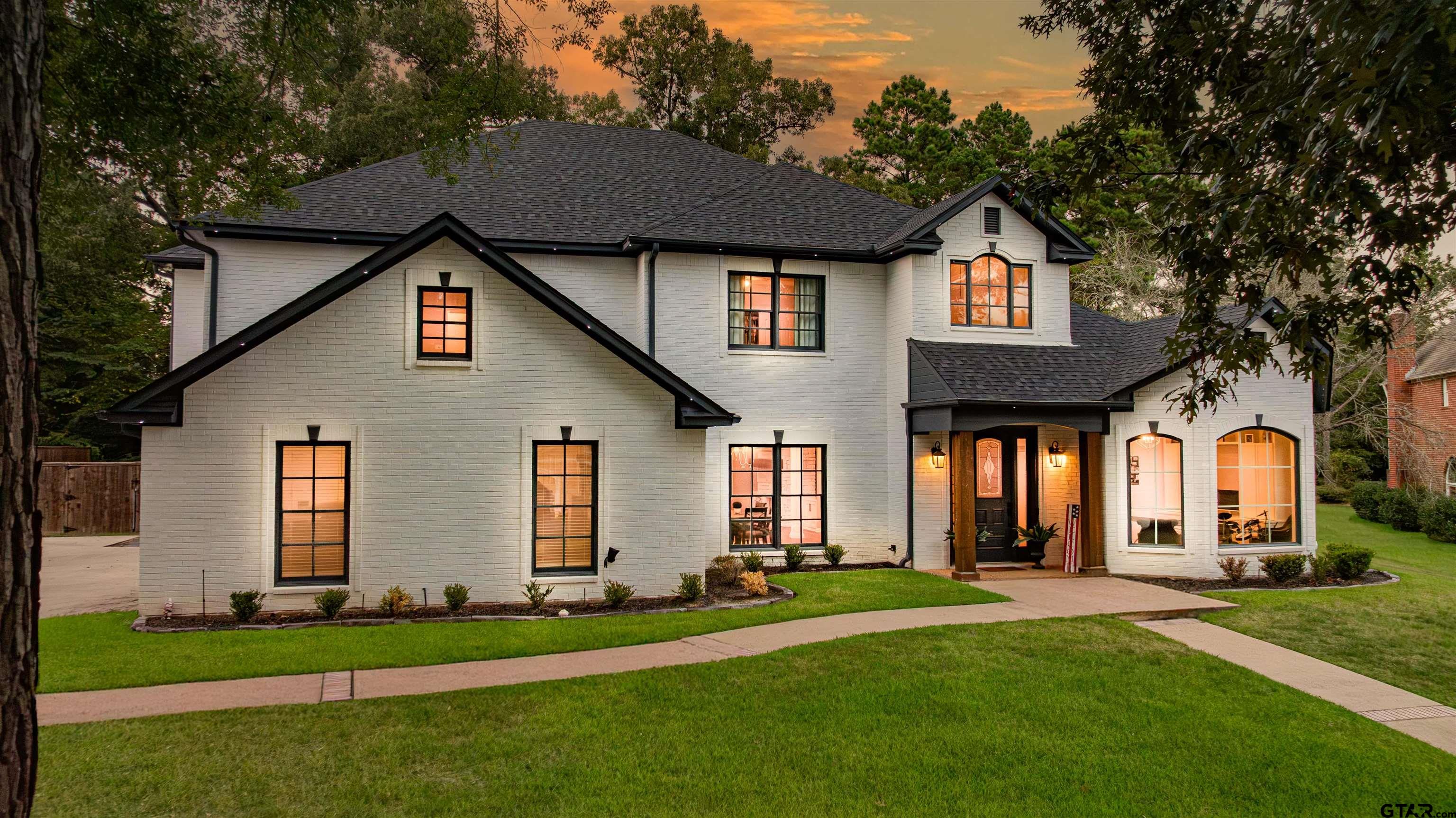 a front view of a house with a garden