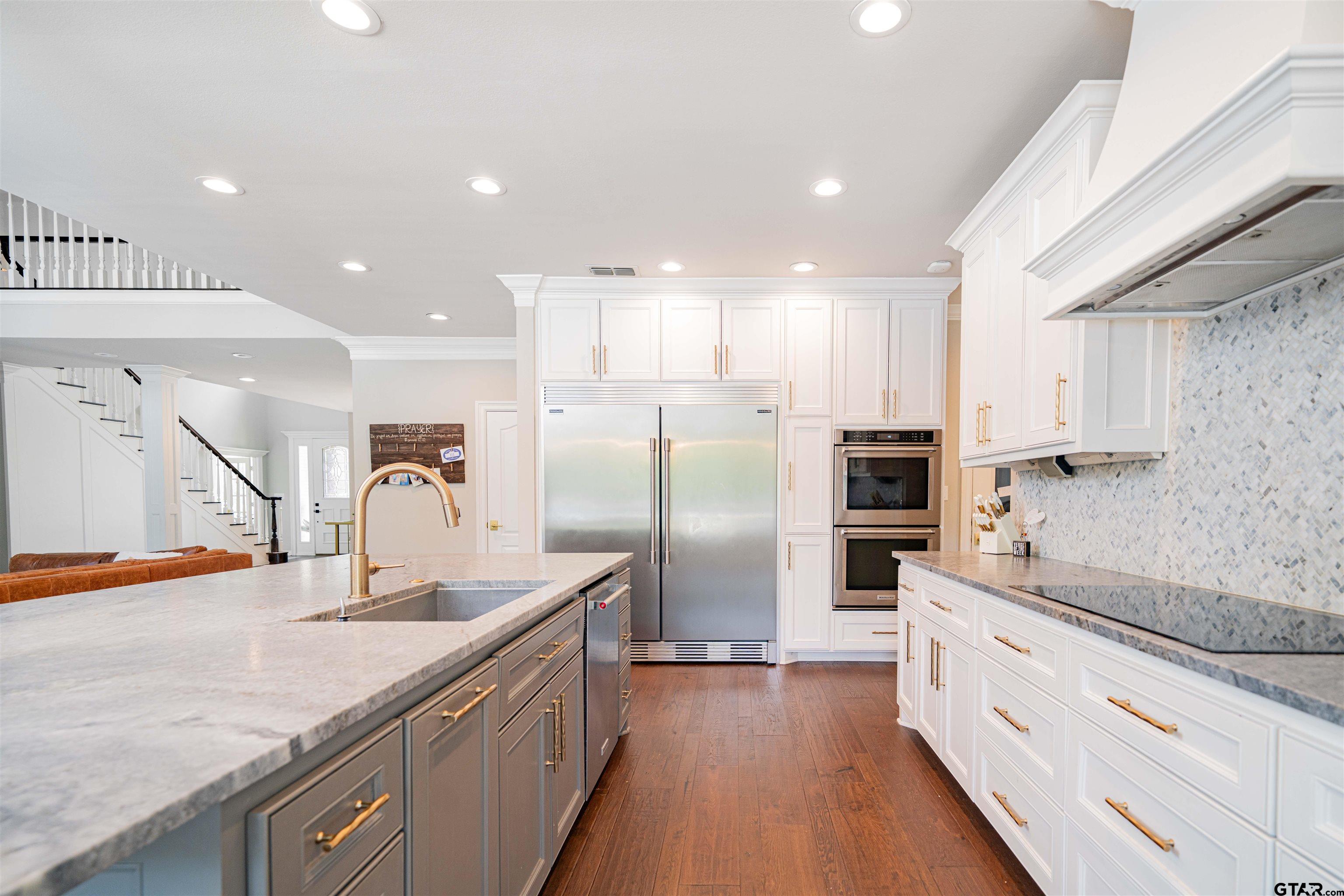 219 Hunters Circle Longview, TX 75605 - Photo 11 of 47 a kitchen with stainless steel appliances granite countertop a sink and a refrigerator