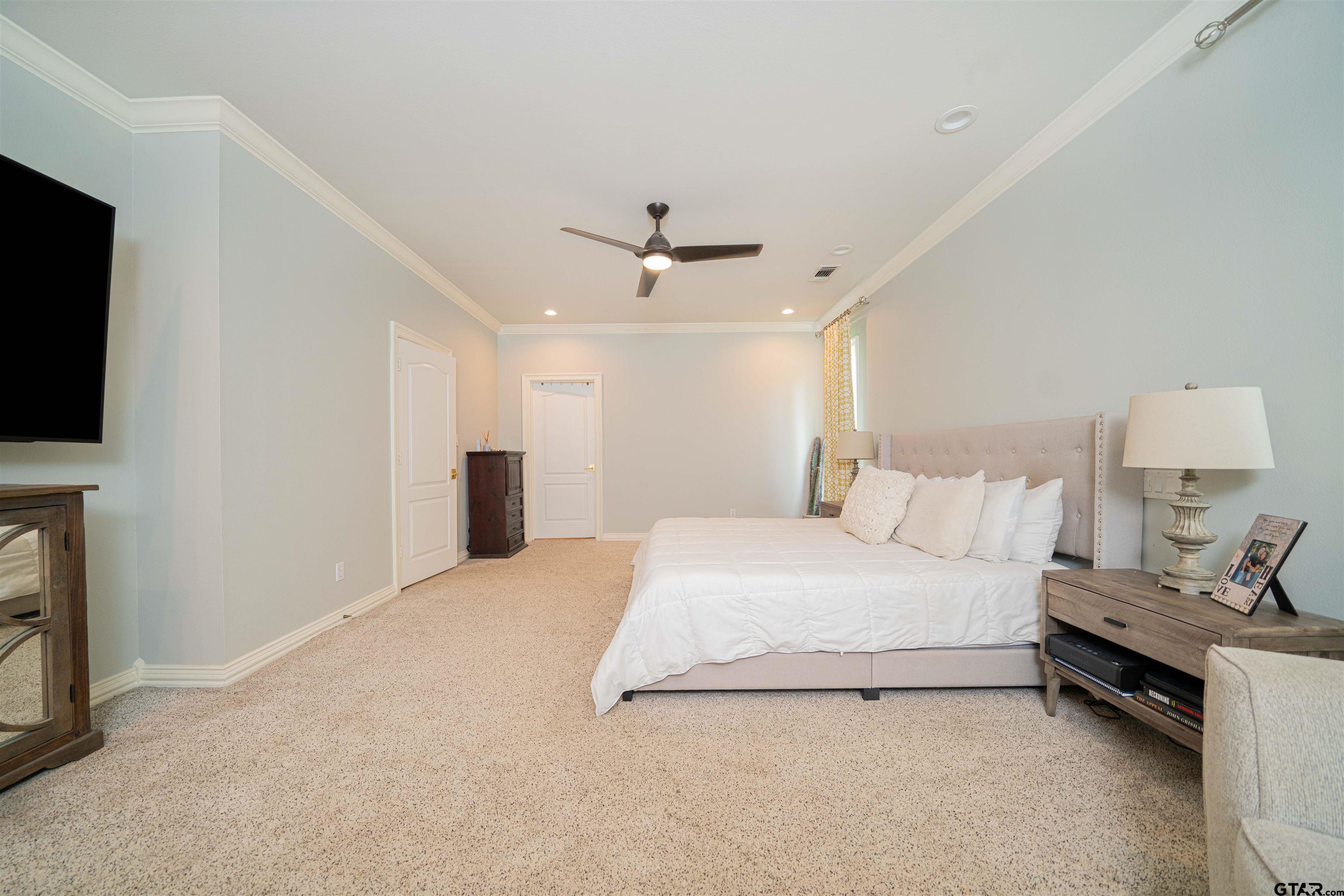 219 Hunters Circle Longview, TX 75605 - Photo 16 of 47 a spacious bedroom with a bed and a flat screen tv