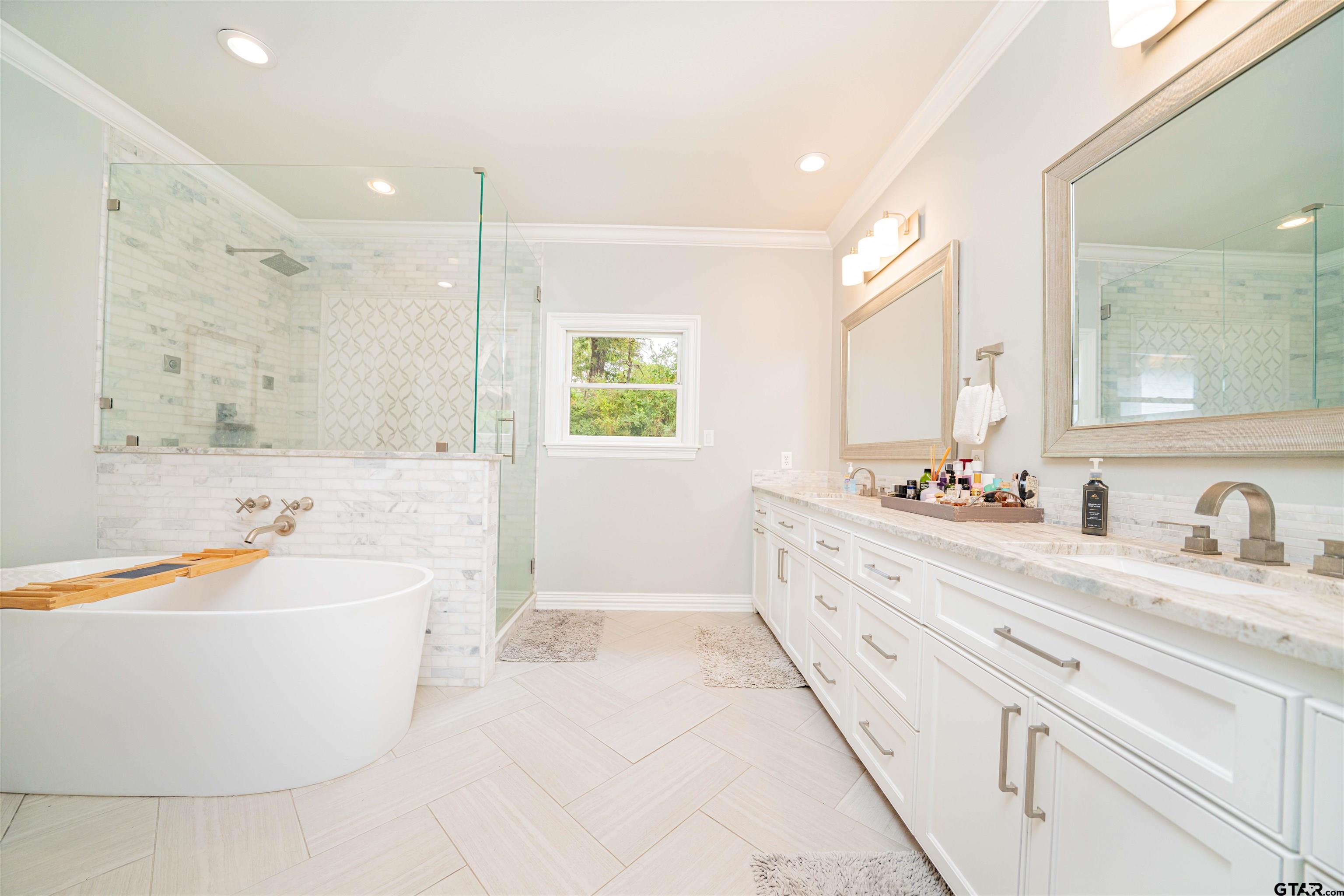 219 Hunters Circle Longview, TX 75605 - Photo 18 of 47 a spacious bathroom with a tub sink and mirror