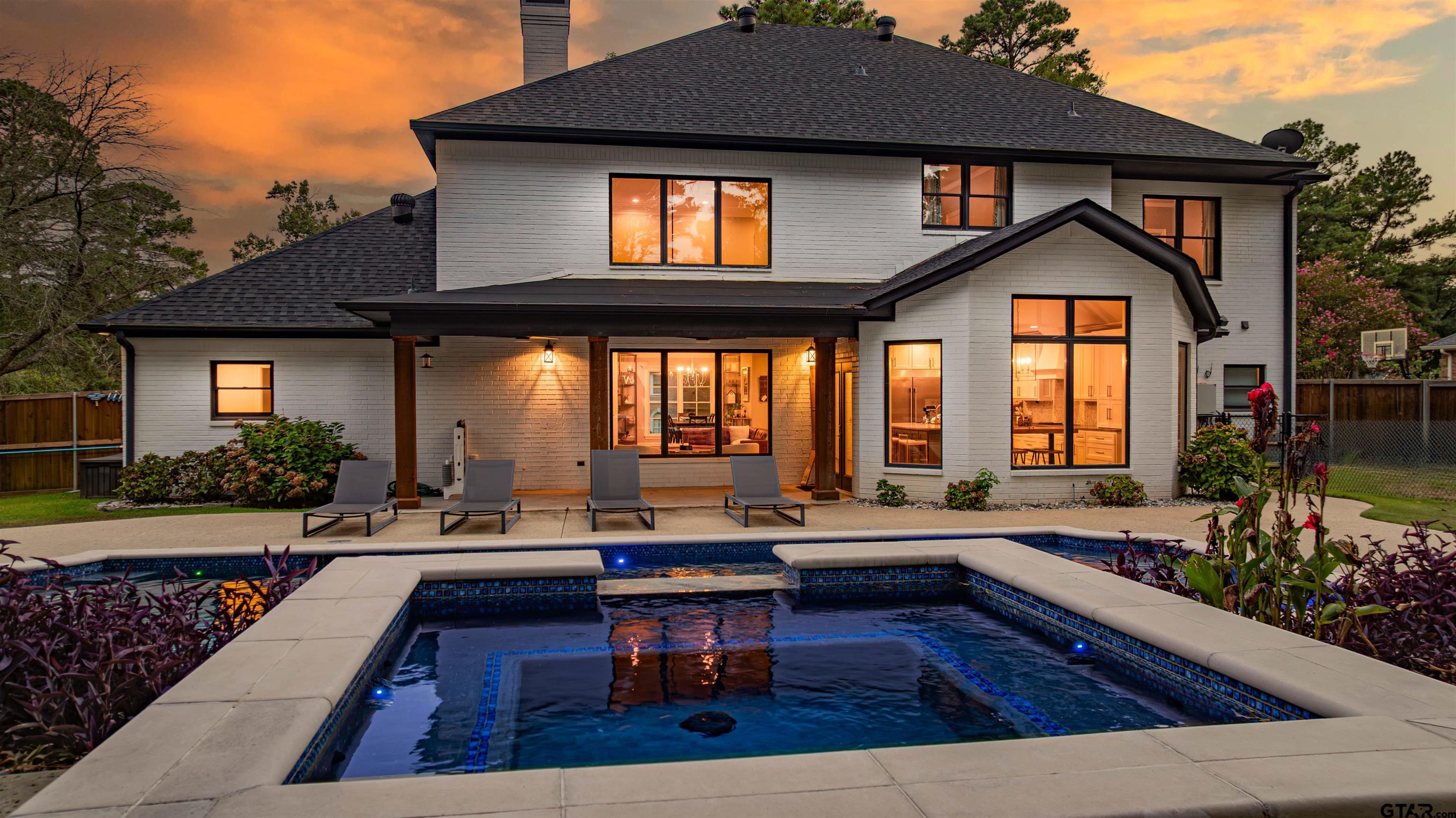 219 Hunters Circle Longview, TX 75605 - Photo 2 of 47 a living room with patio furniture and a fireplace