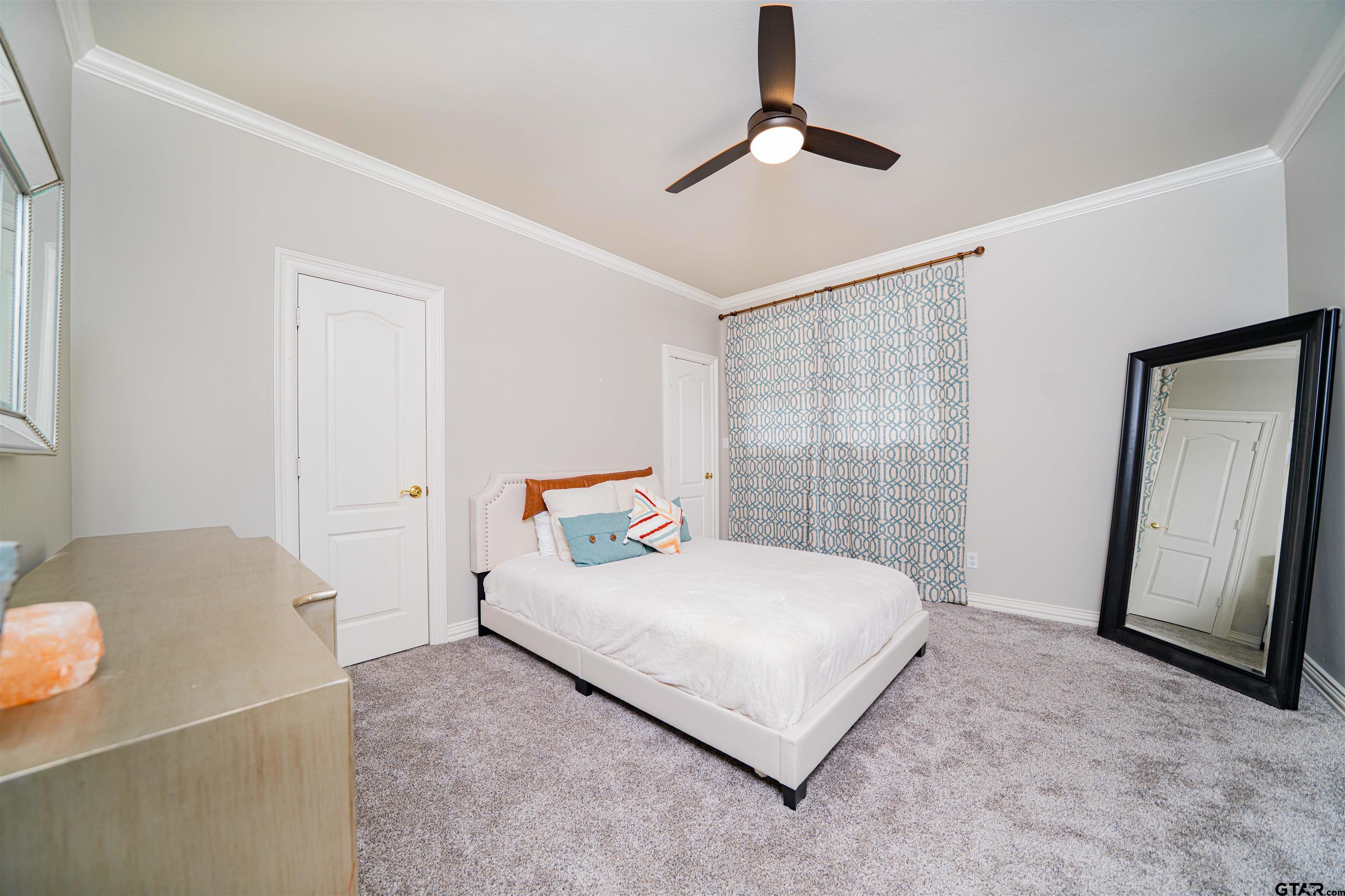 219 Hunters Circle Longview, TX 75605 - Photo 22 of 47 a bedroom with a bed and a mirror