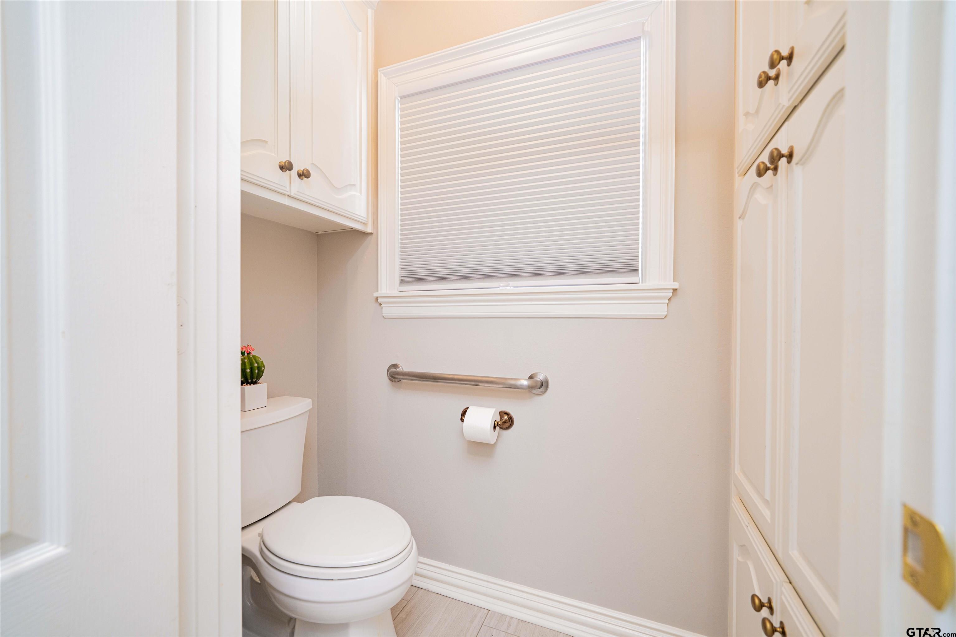 219 Hunters Circle Longview, TX 75605 - Photo 29 of 47 a white toilet sitting next to a bathroom sink