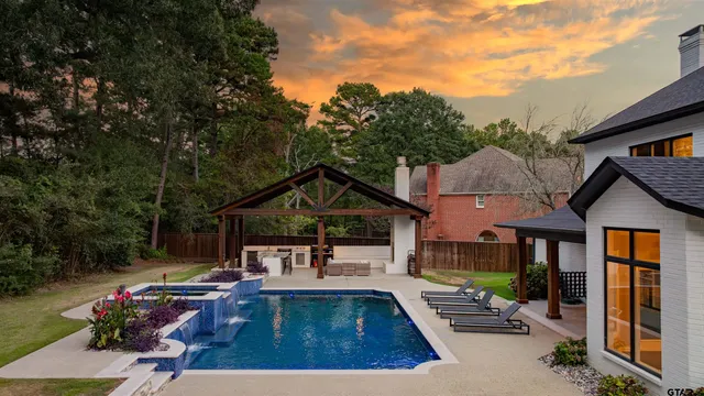 a front view of house with yard and swimming pool