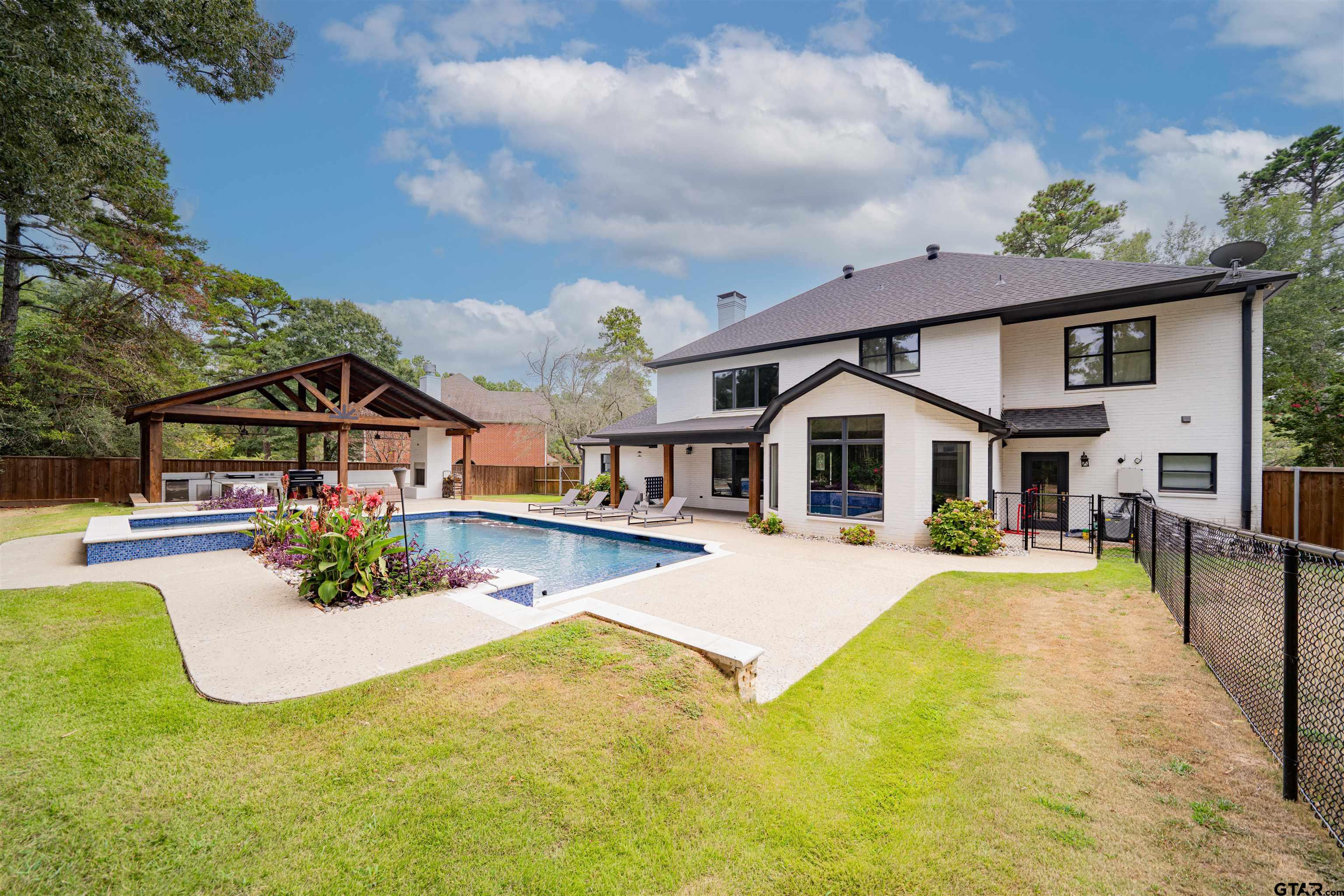 219 Hunters Circle Longview, TX 75605 - Photo 34 of 47 a front view of house with yard and swimming pool
