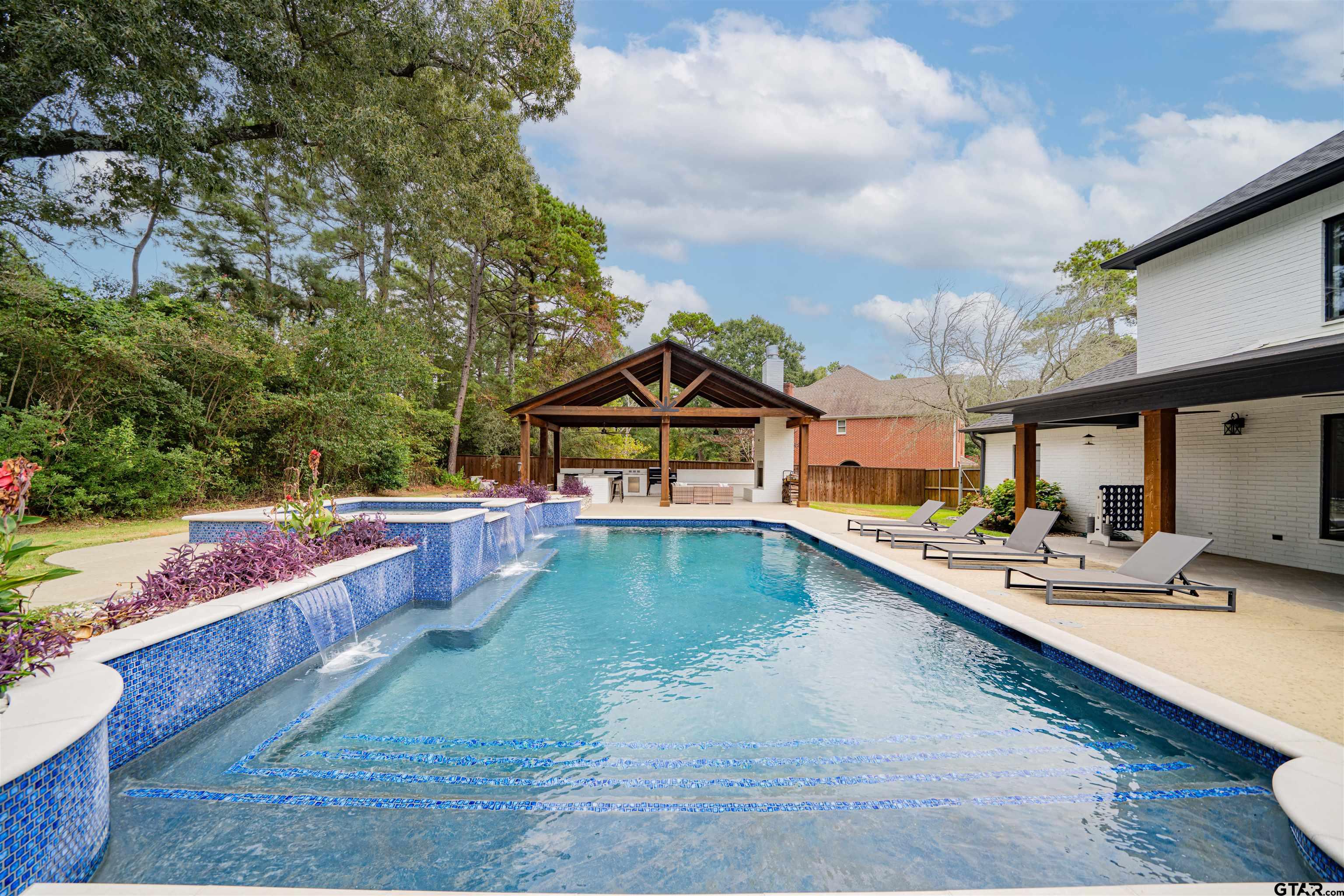 219 Hunters Circle Longview, TX 75605 - Photo 36 of 47 a view of a house with swimming pool and sitting area