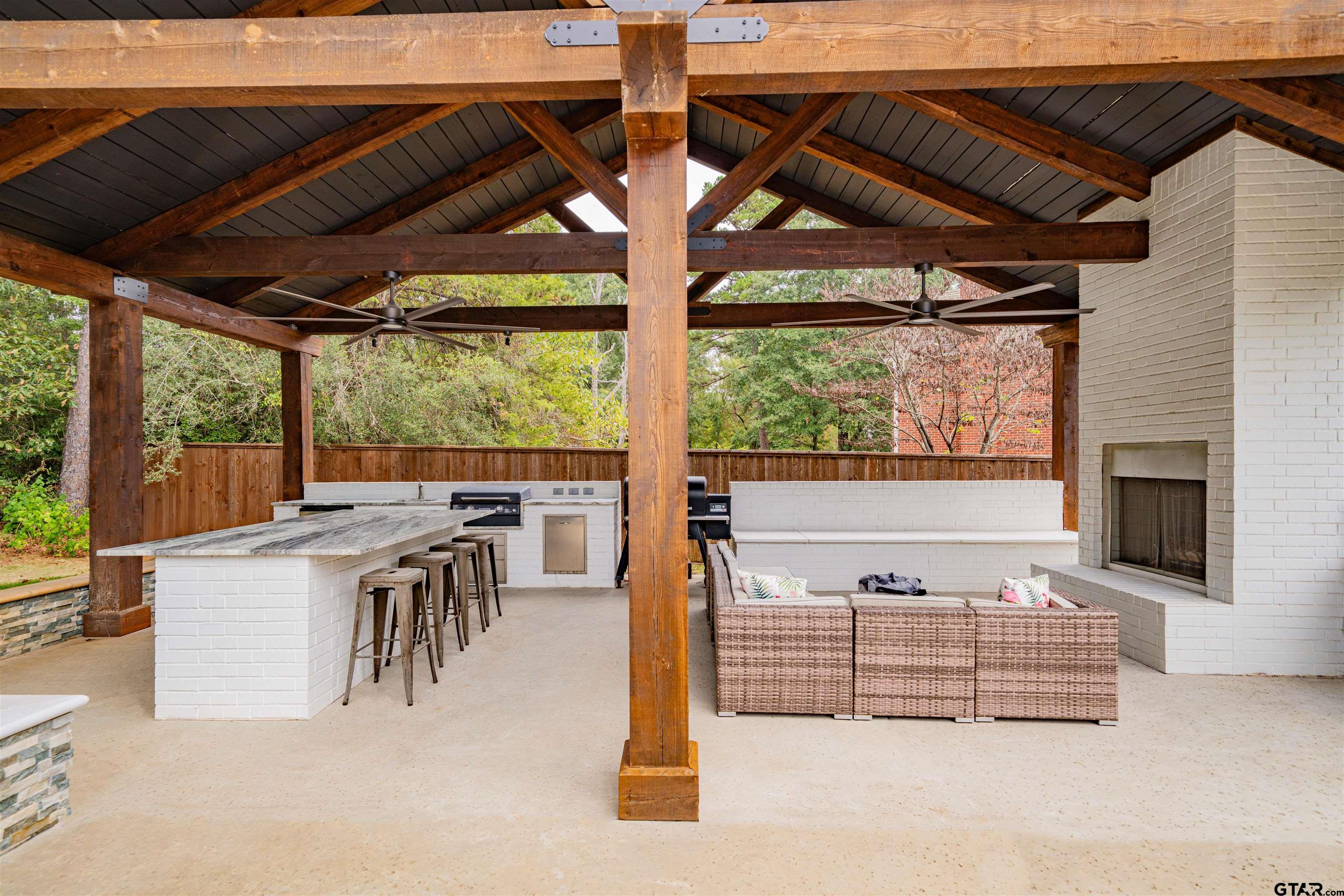 219 Hunters Circle Longview, TX 75605 - Photo 40 of 47 a view of a patio with table and chairs potted plants and floor to ceiling window
