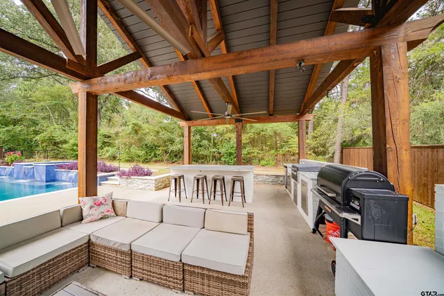 a view of a yard in front of a house with plants and large tree