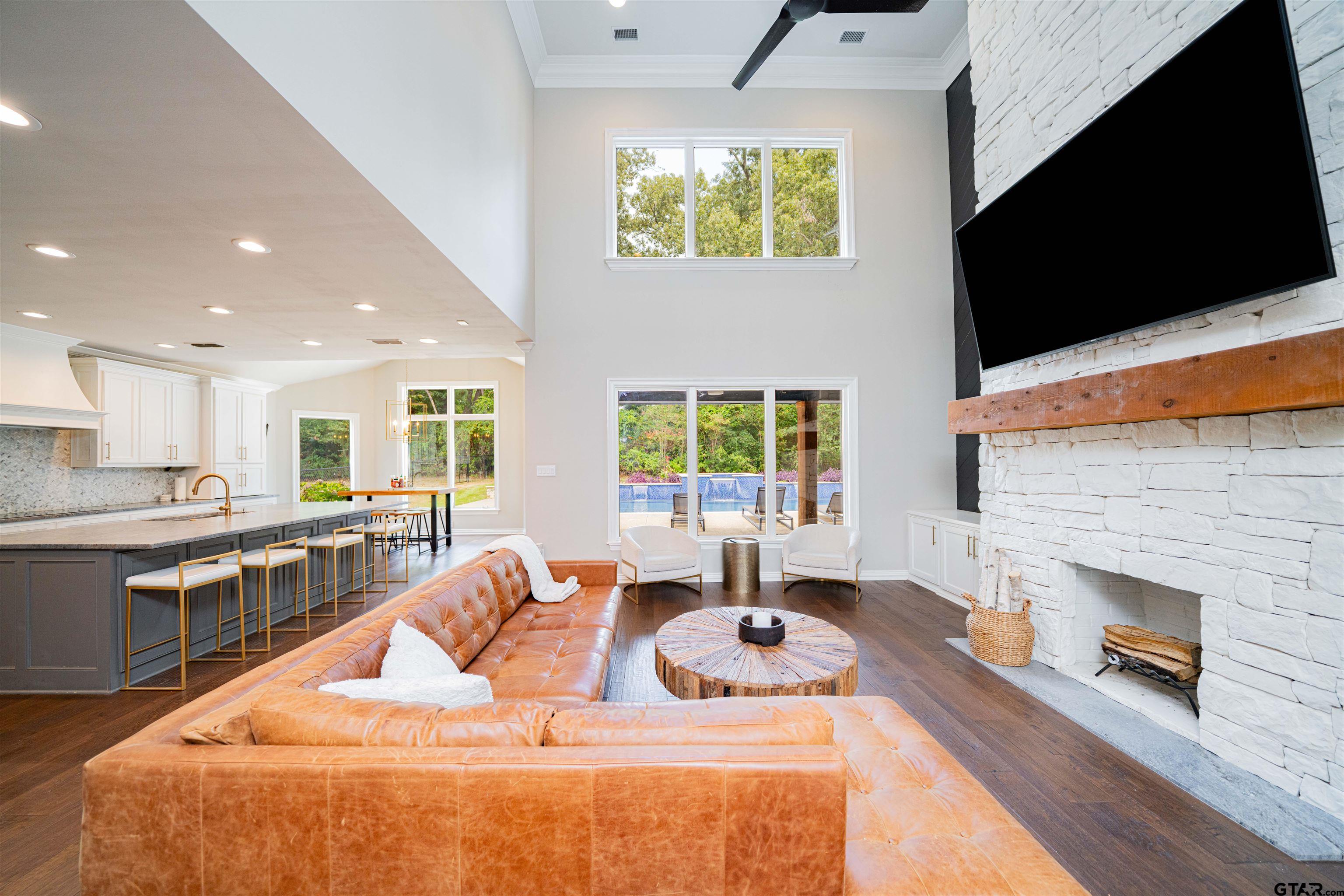 219 Hunters Circle Longview, TX 75605 - Photo 7 of 47 a dining room with fireplace furniture and a flat screen tv